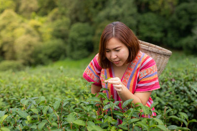 Portrait of a beautiful young woman holding plants