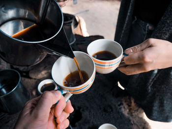 Midsection of woman holding coffee cup