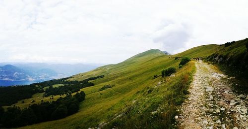 Footpath on mountains against sky