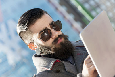 Low angle view of man using mobile phone