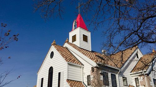 Low angle view of flags against blue sky