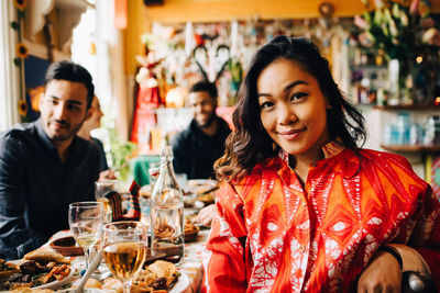 Portrait of smiling woman sitting at restaurant