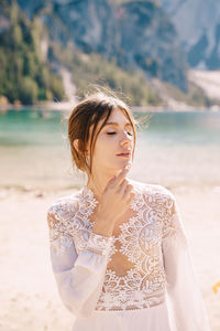 Young woman standing at beach