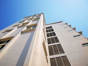 Low angle view of modern building against clear blue sky