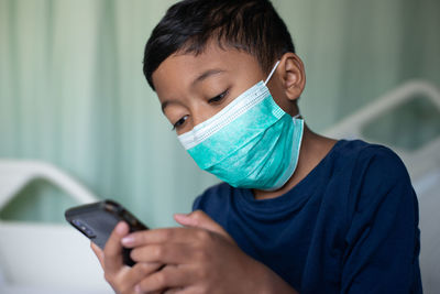 Portrait of boy using mobile phone