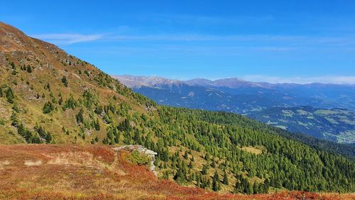 Scenic view of mountains against blue sky
