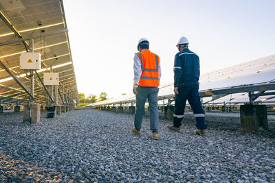 Rear view of people working at construction site