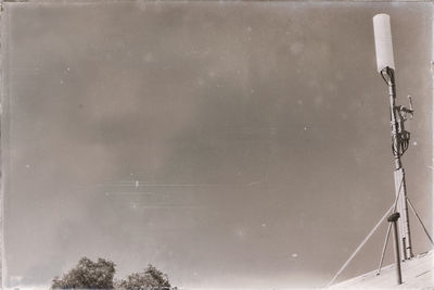 Low angle view of telephone pole against sky