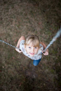 Portrait of cute girl on swing