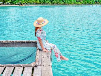 Full length of woman relaxing in sea