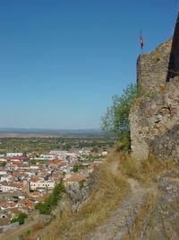 Scenic view of buildings against clear blue sky
