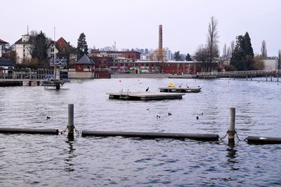 Boats in river with buildings in background