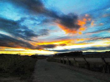 Scenic view of landscape against dramatic sky