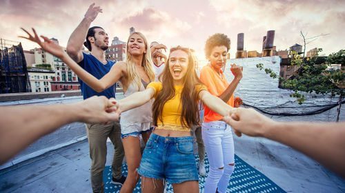 Happy friends on building terrace