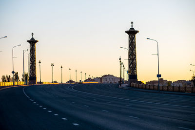 View of street and buildings against sky during sunset