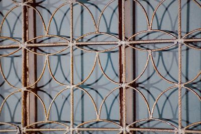 Full frame shot of metal fence against window