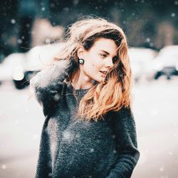 Portrait of smiling woman with snow