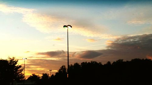 Low angle view of silhouette trees against sky at sunset