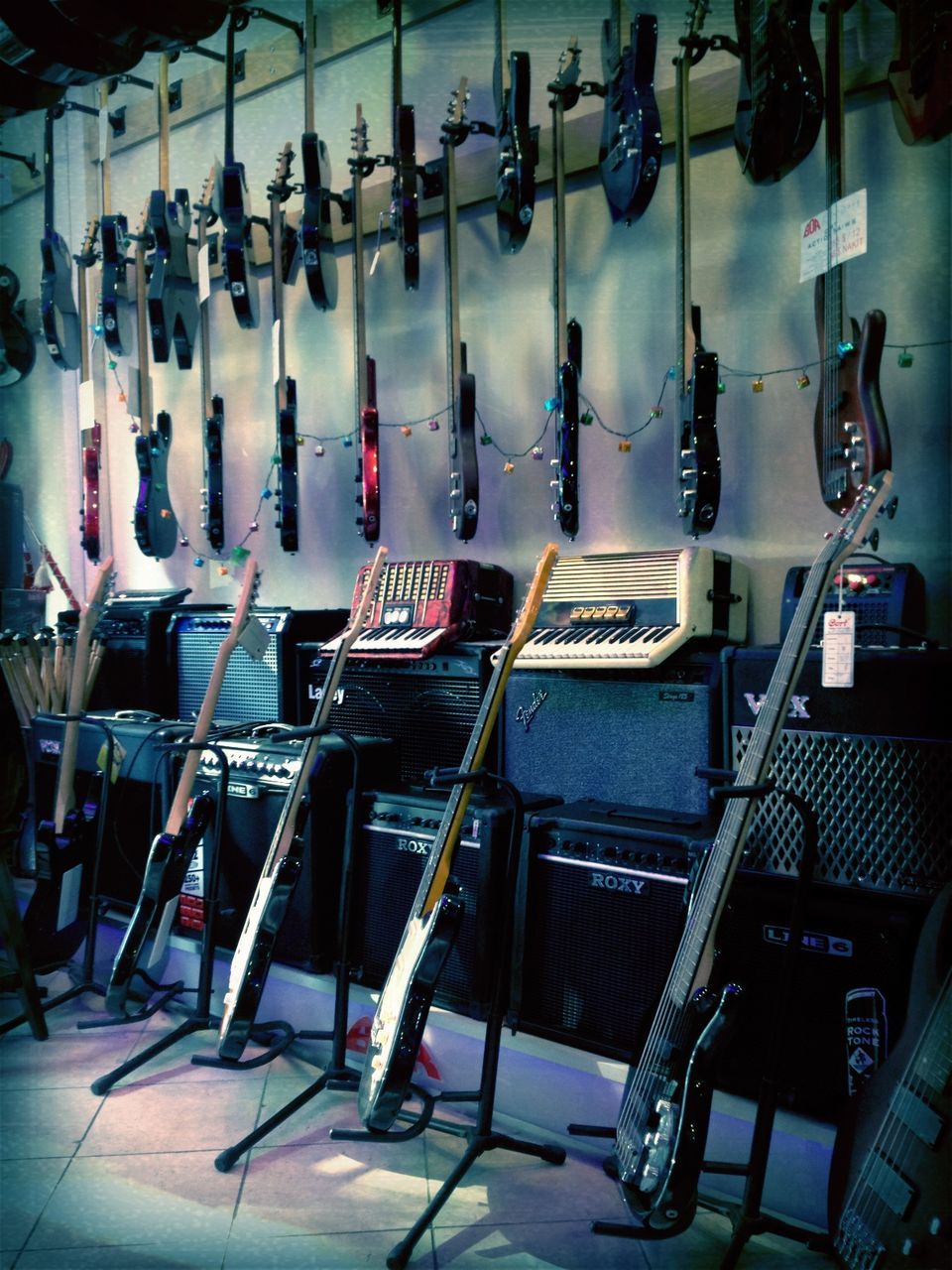 indoors, large group of objects, in a row, arrangement, order, abundance, repetition, hanging, still life, variation, side by side, metal, choice, no people, arranged, chair, technology, absence, arts culture and entertainment, retail