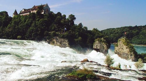 Scenic view of waterfall against sky