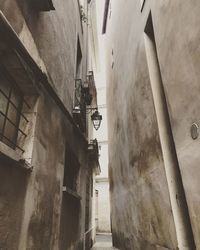 Low angle view of narrow alley amidst buildings