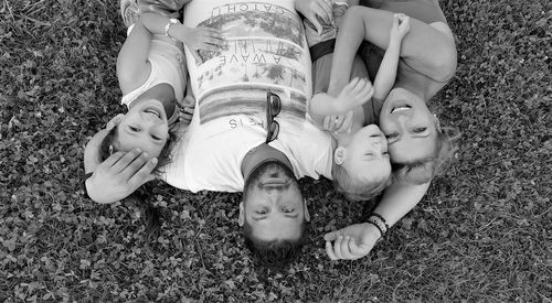 Portrait of happy family lying on grassy land