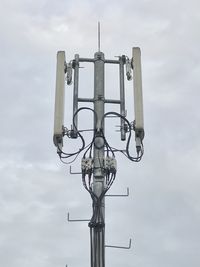 Low angle view of telephone pole against sky