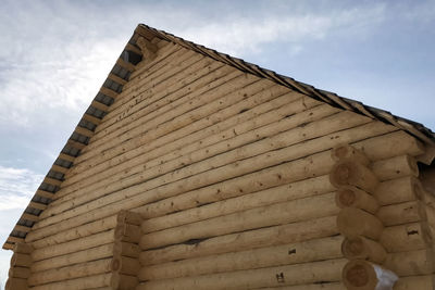 Low angle view of building roof against sky