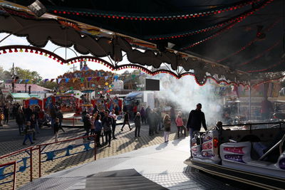 People at amusement park in city