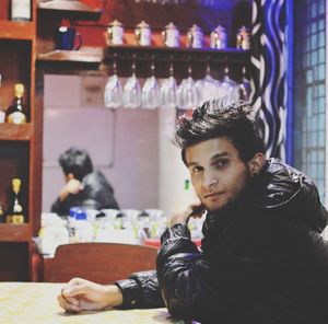 Portrait of young man sitting in bar