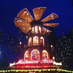 Illuminated traditional building against sky at night