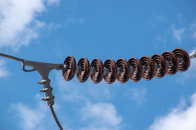 Low angle view of telephone pole against sky