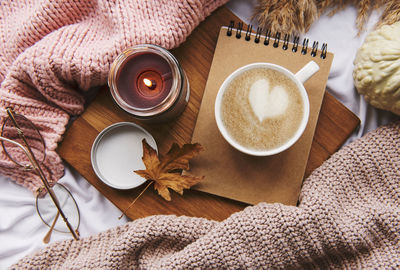 Autumn still life with pumpkins, coffee and burning candles. cozy fall composition