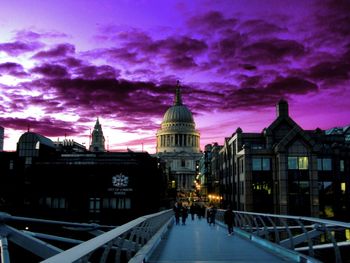 Buildings in city against cloudy sky