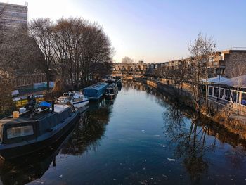 Boats moored in canal along buildings