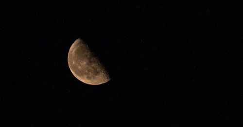 Low angle view of moon against clear sky at night