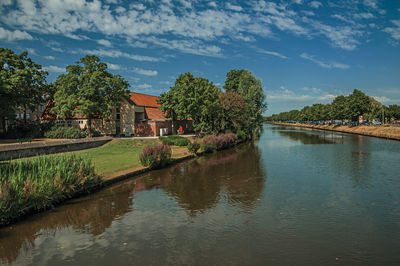 Canal that surrounds the city center of bruges. a town full of canals and old buildings in belgium.