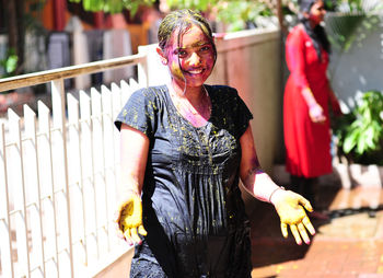 Girl playing with colors on the festival of holi.