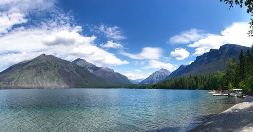 Scenic view of lake by mountains against sky