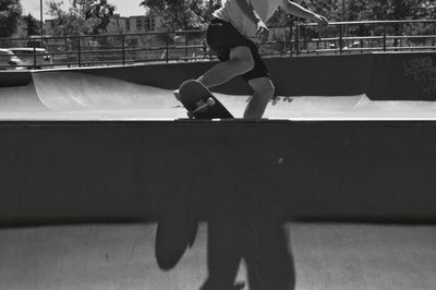 Low section of man skateboarding at skate park