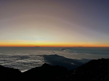 Scenic view of mountain against sky during sunrise