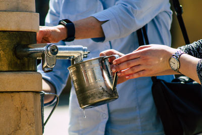 Close-up of man pouring wine in glass