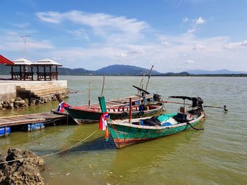 Boat moored in sea against sky