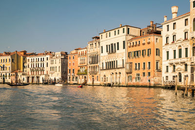 Canal passing through buildings in city