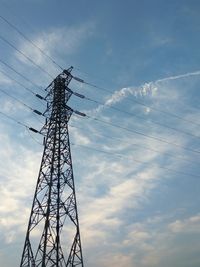 Low angle view of silhouette electricity pylon against sky