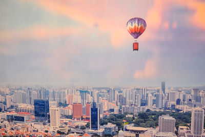 Aerial view of buildings in city against sky