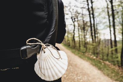 Rear view of man with animal sell tied up on his backpack