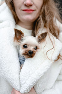 Close-up of young woman with dog