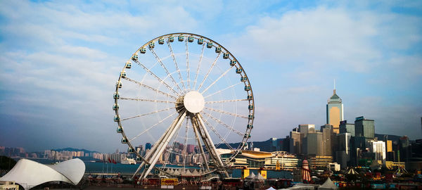 Ferris wheel in city against sky