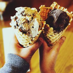 Cropped image of women hands holding ice cream cones